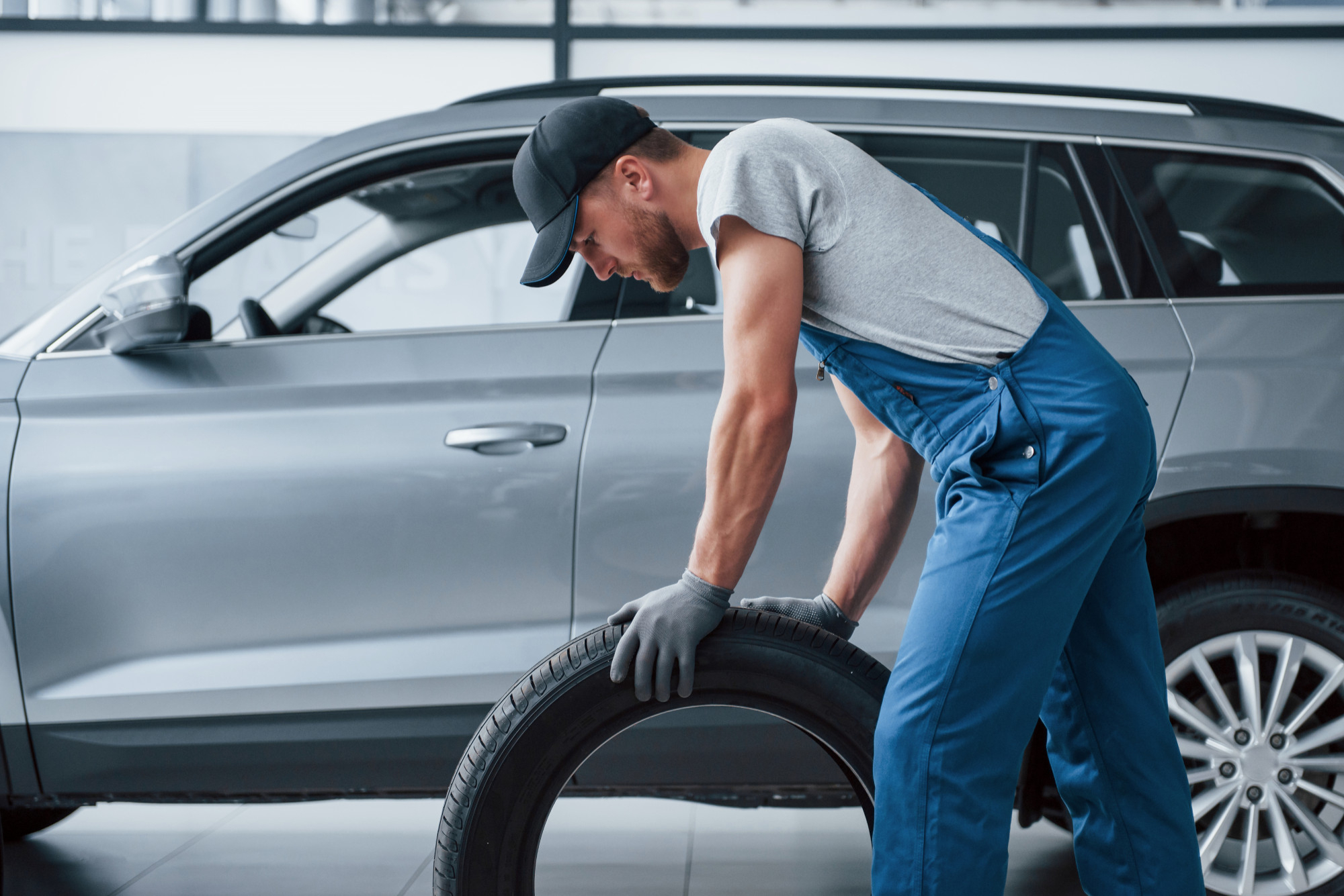 Man with a tyre and about to change the tyre